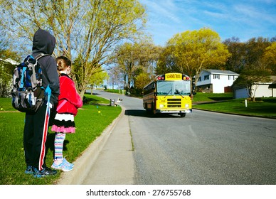 EAU CLAIRE, USA â?? April 29, 2015. Young Girl And Boy Waiting The Schoolbus