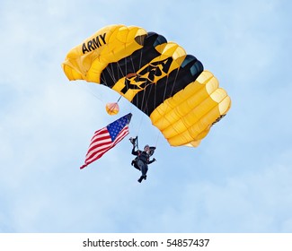 EAU CLAIRE, WI - JUNE 6: A Closeup Of A Member Of The U.S. Army Golden Knights Parachute Team On Her Descent With A United States Flag At The Chippewa Valley Airshow In Eau Claire, WI On June 6, 2010.