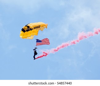 EAU CLAIRE, WI - JUNE 6: A Member Of The U.S. Army Golden Knights Parachute Team On Her Descent With A United States Flag At The Chippewa Valley Airshow In Eau Claire, WI On June 6, 2010.