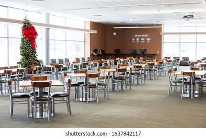 Eau Claire, WI, USA - December, 20, 2019: Chippewa Valley Technical College. Empty Cafe With Christmas Tree. Interior Of College Canteen With Chairs, Tables And Computers. Free Wi-fi Zone