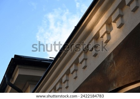 the eaves of the street facade of the historic building with dentils