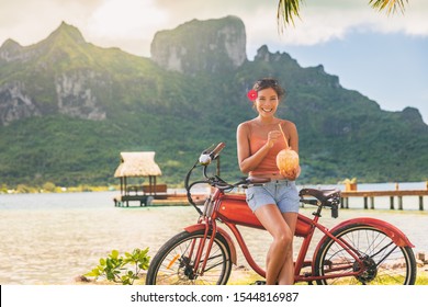 E-bike Tourist Travel Woman Biking On Electric Bicycle Rental In Bora Bora, French Polynesia Tahiti Island Tourism Summer Vacations. Adventure Fun Cyclist On Bike.