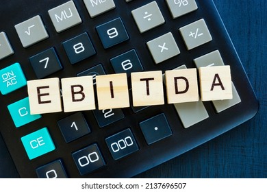 EBITDA Earnings Before Interest, Taxes, Depreciation, and Amortization concept. Letters on the calculator. - Shutterstock ID 2137696507