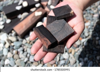 ebony wood bars for crafts in hand - Shutterstock ID 1785505991