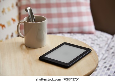 ebook device with blank screen on a table. The e-book device is a dedicated device for reading e-books. - Powered by Shutterstock