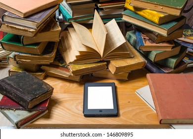 Ebook and old books on table