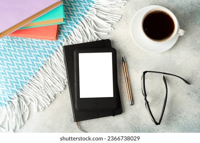 E-book reader, cup of coffee and glasses on gray surface - Shutterstock ID 2366738029