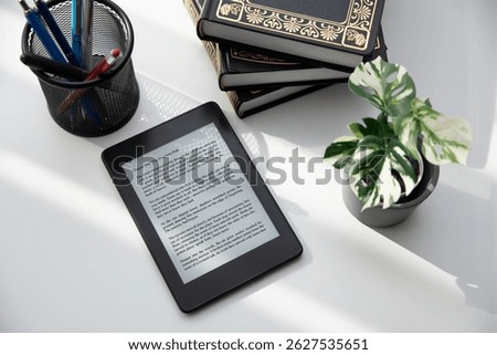 E-book reader device in home library, top view