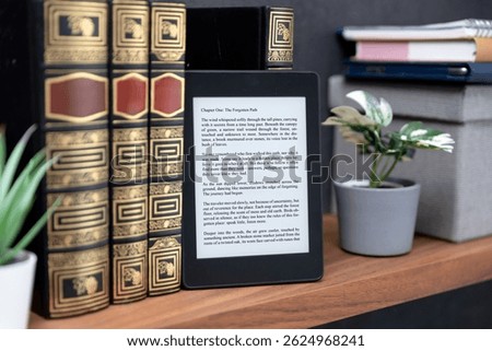 E-book reader device on shelf in home library