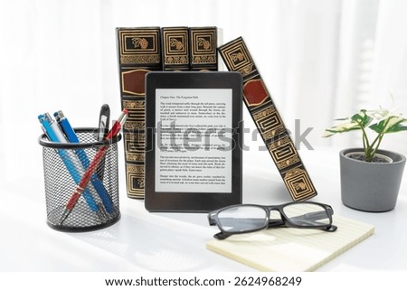 E-book reader device on table in home library