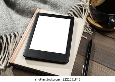 E-book reader with notebook and coffee on wooden table, closeup. Space for text - Shutterstock ID 2221851945
