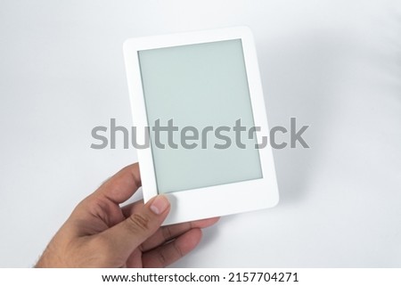 Ebook reader over isolated white background - being held by a male hand