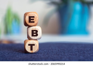 EBT - acronym from wooden blocks with letters, Earnings before interest, taxes, depreciation and amortization.