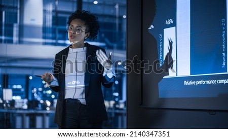 e-Business Technology Conference Presentation: Innovative Black Tech Engineer Talks about Revolutionary High-Tech Product. Projector Screen Shows Graphs, Infographics, AI, Big Data, Machine Learning