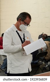  ECATEPEC DE MORELOS, MÉXICO, 24 FEBRUARY 2021: Young Doctor Writing Down The Vaccination Control Against Covid 19 At The Melchor Muzquiz Civic Center In Ecatepec                             