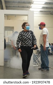  ECATEPEC DE MORELOS, MÉXICO, 24 FEBRUARY 2021: A 60-year-old Woman Entering The Covid 19 Vaccination Area In The Melchor Muzquiz Civic Center In Ecatepec, Going Through A Sanitizing Tunnel           