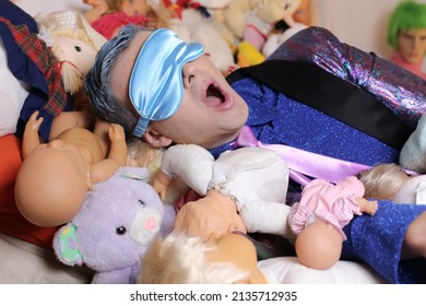 Eccentric Man Surrounded By Weird Dolls Snoring 