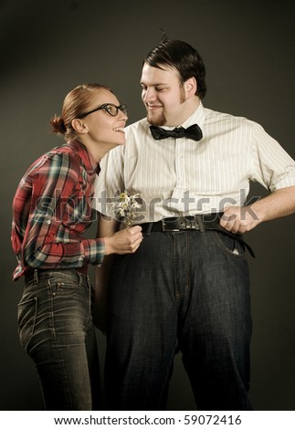 eccentric young couple on dark background
