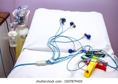 ECG Or EKG Electrodes For Electrocardiogram Records Patient Heartbeats On Bed In Hospital.