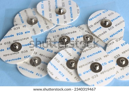Ecgekg (eletrocardiogram) electrode in a light blue background 
