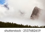 Echo Rock Stands Out Below A Peek Of Mount Rainier Through The Fog from Wonderland Trail