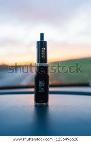 E-Cigarette inside the car with steam and sunlight