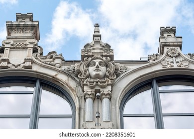 Eclecticism In Architecture, Head Sculpture Classic Antique Building Exterior Detail Up Close, Old Tenement House Front View, Closeup, Nobody. Old Building Stone Sculpture Decorations Concept, Europe