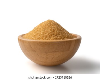 Eco bio brown sugar in wooden bowl isolated on white background with clipping path. Raw unrefined organic cane sugar pile side view