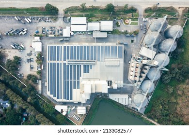 Eco Building Or Factory In Aerial View Consist Of Solar Or Photovoltaic Cell In Panel On Top Of Roof. Technology To Generate Electrical Power, Direct Current Electricity By Light. Energy For Future.