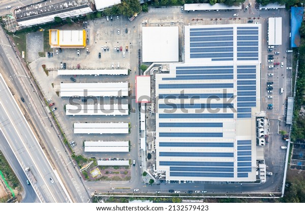 Eco building or supermarket in aerial view\
consist of solar or photovoltaic cell in panel on top of roof.\
Technology to generate electrical power, direct current electricity\
by light for future.\
