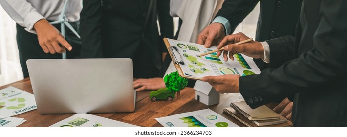 Eco business company meeting with group of business people using laptop to plan strategy and discuss marketing of eco-friendly and clean energy products. Green business company concept. Trailblazing - Powered by Shutterstock