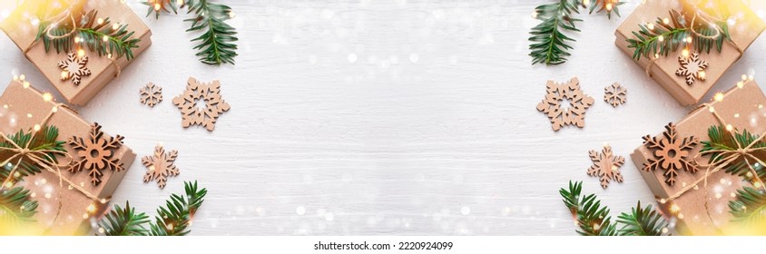  Eco Christmas holiday background. Xmas Craft wooden decoration gift boxes and snowflakes. Christmas lights. Space for text. Banner.                                - Powered by Shutterstock