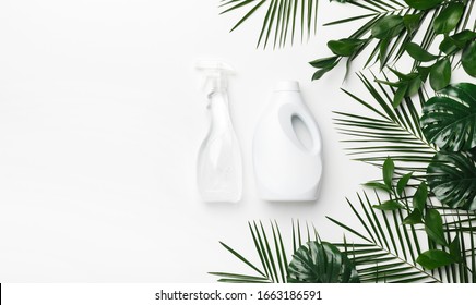 Eco Cleaning Detergent In White Plastic Bottles With Green Leaves On White Background, Copy Space. Eco Recycling Cleaning Product