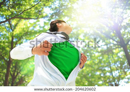 ECO concept - Business man opens his shirt to show off his green copy space in forest trees