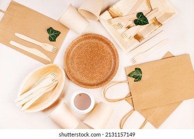 Eco craft paper tableware,cups,fast food containers.Recycling,eco-friendly concept.Disposable eco cutlery,plates,spoons,knives,forks on a light background.Craft paper bag for food delivery.Copy space. - Shutterstock ID 2131157149