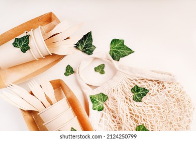 Eco Craft Paper Tableware.Fabric Bag For Food Delivery.Paper Cups,fast Food Containers.Recycling,eco-friendly Concept.Disposable Eco Cutlery,plates,spoons,knives,forks On A Light Background.Copy Space