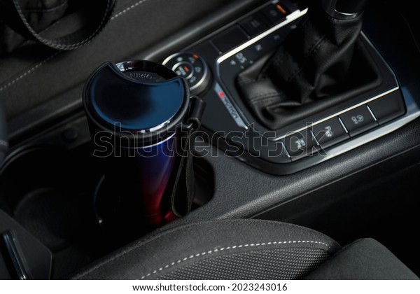 Eco cup with coffee in holder inside car. High\
quality photo