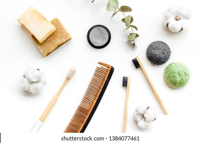 Eco Friendly Bamboo Tooth Brush And Carbon Toothpaste, Comb, Organic Soap On White Background Top View