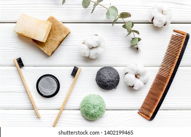 Eco Friendly Bamboo Tooth Brush And Carbon Toothpaste, Comb, Organic Soap On White Background Top View