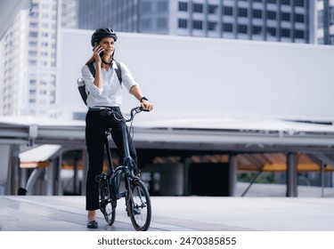 Eco friendly, businesswoman ride bicycle in urban to reduce carbon footprint. Beautiful woman environment conservation person commuting with bicycling. Cycling, alternative transport for green energy. - Powered by Shutterstock