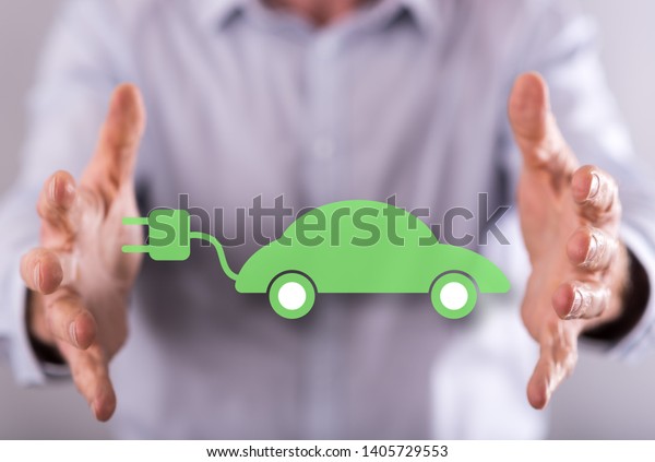 Eco friendly car concept between hands of a\
man in background