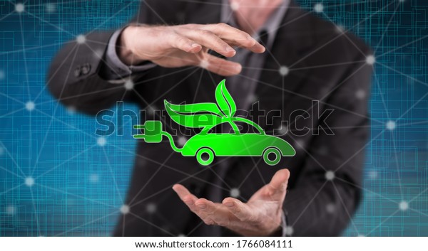 Eco friendly car concept between hands of a\
man in background