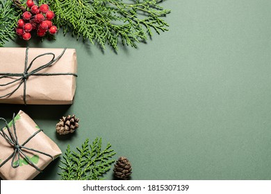 Eco Friendly Christmas Composition With Gift Boxes In Craft Reusable Paper And Natural Decor On Green Background Top View. Zero Waste Environmentally Friendly Christmas Concept. 