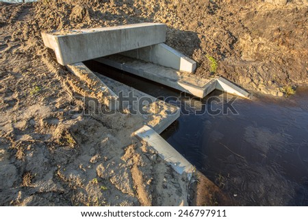 Eco Friendly Culvert under construction with walking strips for animals above the waterline serving as a wildlife crossing