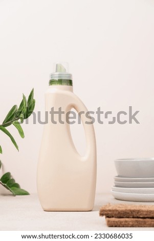 Eco friendly dishwashing. Bottle with detergent and bamboo eco sponges on  light background