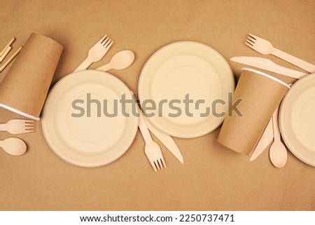 Eco friendly disposable dishware for takeout. Top view scene on a brown paper background. Biodegradable, composable alternative to plastic.