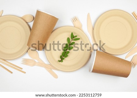 Eco friendly disposable dishware for takeout. Overhead view flat lay on a white background. Biodegradable, composable alternative to plastic.