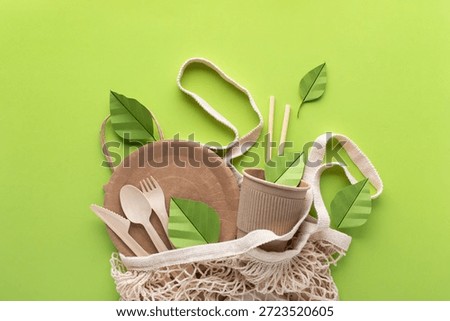 Eco friendly disposable packaging and tableware with paper green leaves top view. Zero waste, sustainable lifestyle and plastic free concept. 