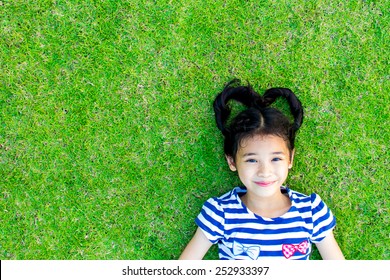 Eco Friendly Environment Concept With Happy Healthy Asian Kid Having Fun Relaxing Outdoor On Natural Green Lawn Living In Beautiful Nature 