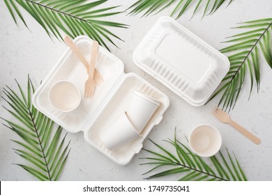 Eco friendly food packaging on white quartz background, flat lay